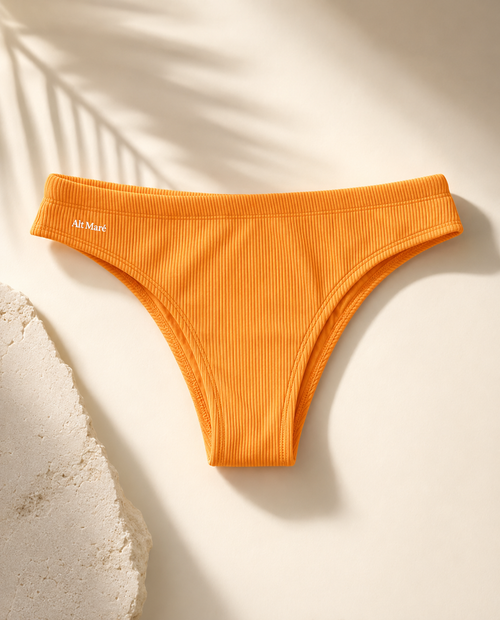 Alt Maré The Euro men's swim briefs in saffron yellow, ribbed fabric flat lay with palm shadow